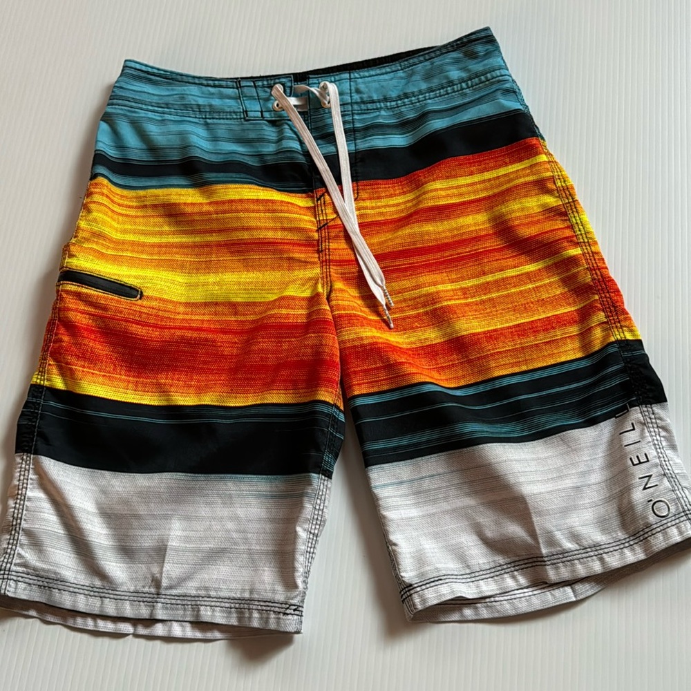 O’Neill blue, orange, yellow & gray board shorts. Size 26